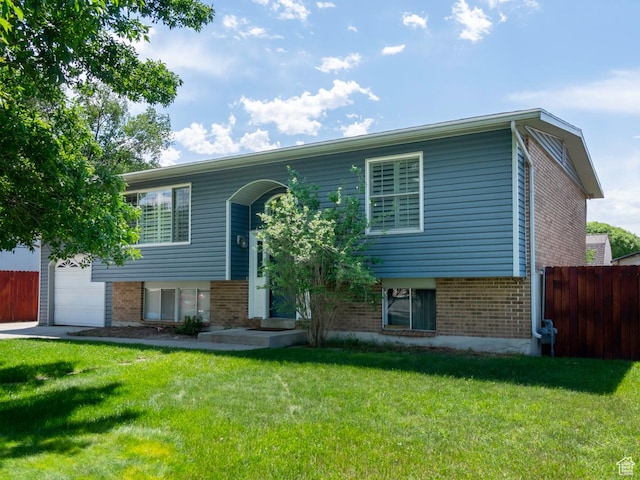 2970 S Mock Orange Dr W, West Valley City, UT 84119 - raised ranch featuring brick siding and an attached garage