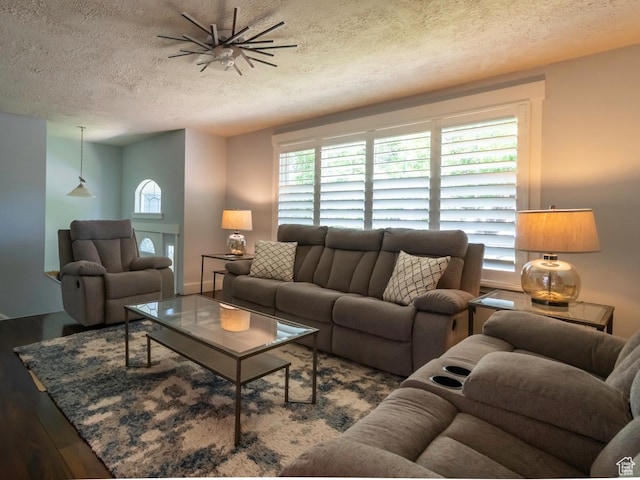 2970 S Mock Orange Dr W, West Valley City, UT 84119 - living area featuring wood finished floors, a textured ceiling, and healthy amount of natural light