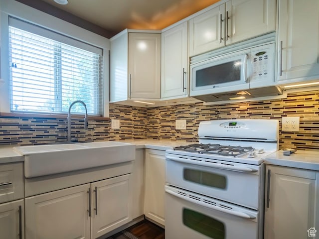 2970 S Mock Orange Dr W, West Valley City, UT 84119 - kitchen featuring white appliances, light countertops, and white cabinetry