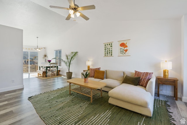 4082 N Poplar Dr, Eagle Mountain, UT 84005 - living area featuring wood finished floors, a ceiling fan, a chandelier, and vaulted ceiling