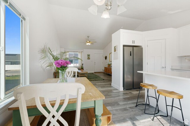 4082 N Poplar Dr, Eagle Mountain, UT 84005 - kitchen with freestanding refrigerator, a ceiling fan, lofted ceiling, white cabinets, and a kitchen breakfast bar