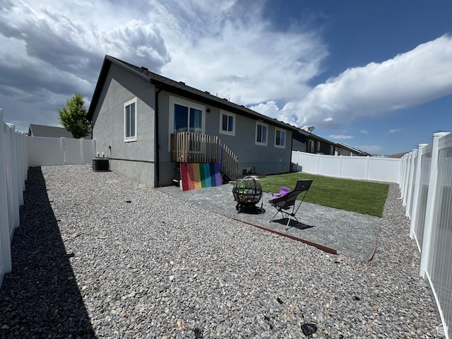 4082 N Poplar Dr, Eagle Mountain, UT 84005 - back of house with a fire pit, a fenced backyard, stucco siding, and a patio area