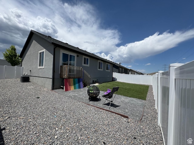 4082 N Poplar Dr, Eagle Mountain, UT 84005 - back of house with a fenced backyard, a fire pit, and stucco siding