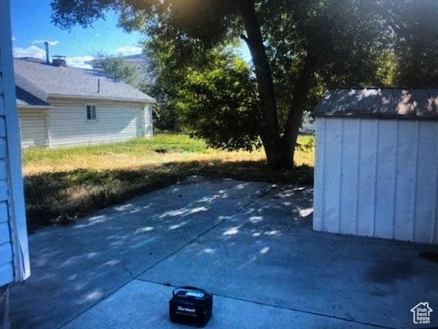 3628 S 5450 W, West Valley City, UT 84120 - view of patio featuring a storage shed