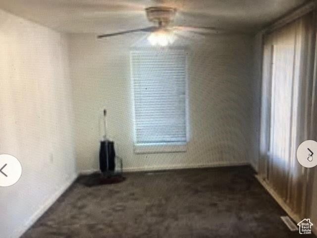 3628 S 5450 W, West Valley City, UT 84120 - unfurnished living room with dark colored carpet and a ceiling fan