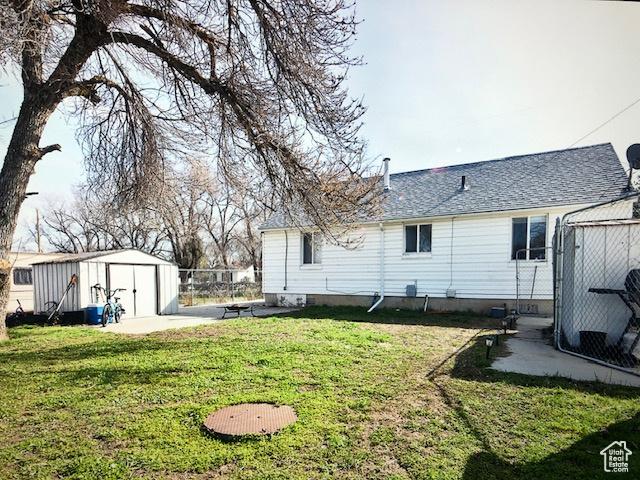 3628 S 5450 W, West Valley City, UT 84120 - view of grassy yard featuring a storage shed and a patio