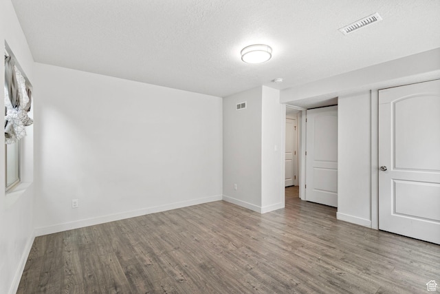 7335 N Harvest Crop Dr, Eagle Mountain, UT 84005 - unfurnished bedroom featuring wood finished floors and a textured ceiling