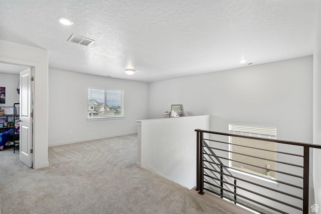 7335 N Harvest Crop Dr, Eagle Mountain, UT 84005 - corridor featuring an upstairs landing, carpet floors, a textured ceiling, and recessed lighting