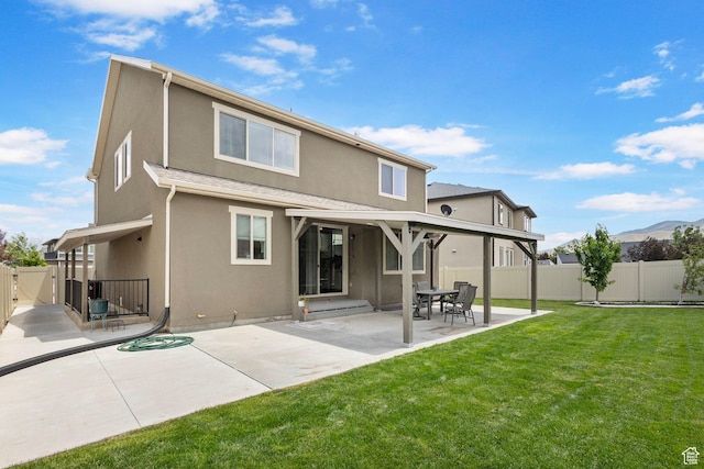7335 N Harvest Crop Dr, Eagle Mountain, UT 84005 - rear view of property with stucco siding, a fenced backyard, a patio area, and a gate