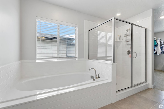 7335 N Harvest Crop Dr, Eagle Mountain, UT 84005 - bathroom featuring a garden tub, tile patterned floors, and a shower stall