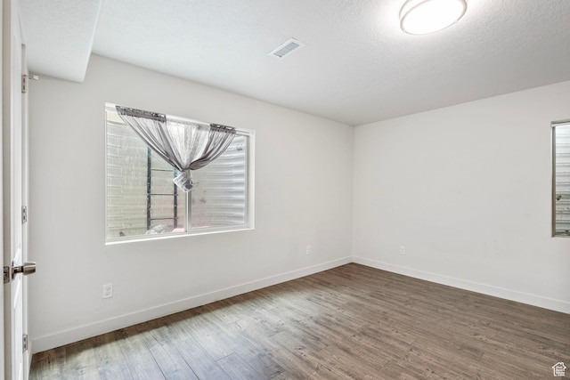 7335 N Harvest Crop Dr, Eagle Mountain, UT 84005 - unfurnished room with wood finished floors and a textured ceiling