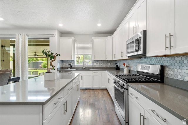 7335 N Harvest Crop Dr, Eagle Mountain, UT 84005 - kitchen featuring stainless steel appliances, recessed lighting, white cabinetry, a center island, and light wood finished floors