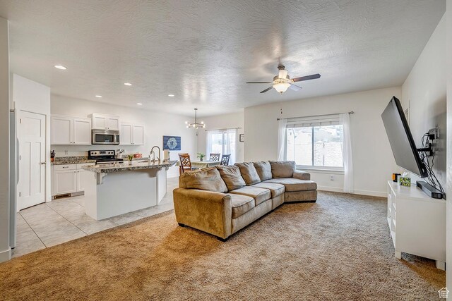 56 N Rue De Matth W, Vineyard, UT 84058 - living area featuring a ceiling fan, light colored carpet, a chandelier, recessed lighting, and a textured ceiling