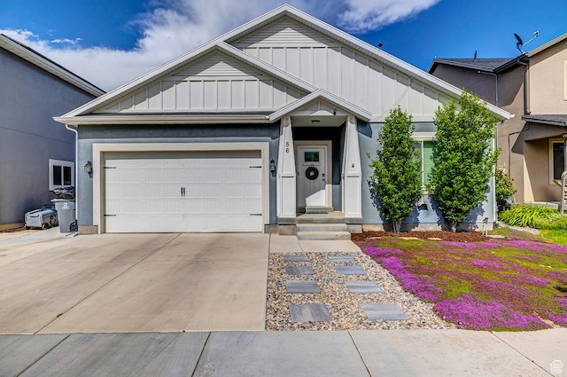 56 N Rue De Matth W, Vineyard, UT 84058 - view of front facade with board and batten siding, an attached garage, and driveway