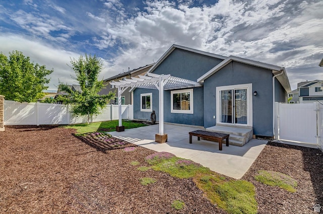 56 N Rue De Matth W, Vineyard, UT 84058 - rear view of house with a pergola, stucco siding, a fenced backyard, a patio area, and a gate
