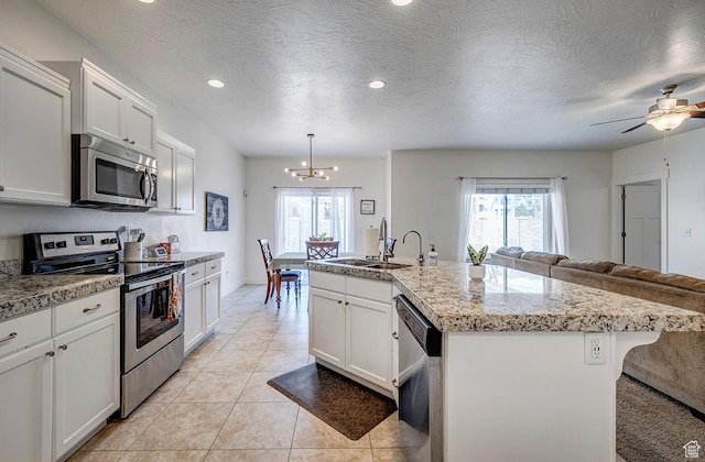 56 N Rue De Matth W, Vineyard, UT 84058 - kitchen featuring stainless steel appliances, open floor plan, a chandelier, an island with sink, and recessed lighting