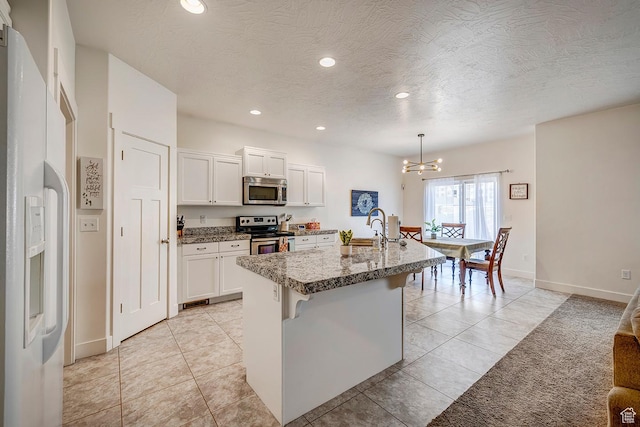 56 N Rue De Matth W, Vineyard, UT 84058 - kitchen with appliances with stainless steel finishes, a chandelier, recessed lighting, white cabinets, and an island with sink