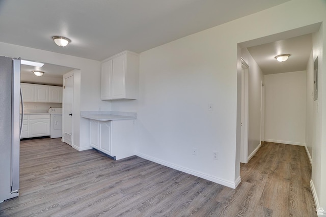 1132 S 1100 W, Provo, UT 84601 - kitchen with washer / clothes dryer, freestanding refrigerator, light wood-style floors, white cabinetry, and light countertops
