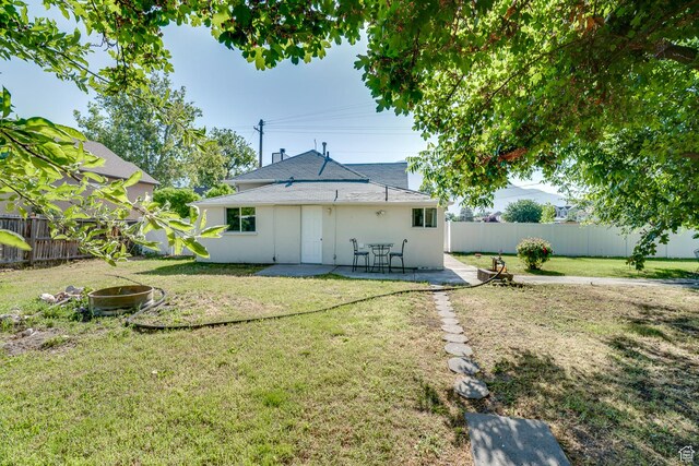 1132 S 1100 W, Provo, UT 84601 - rear view of house featuring a fenced backyard, a patio, and stucco siding