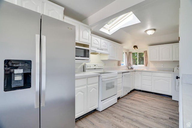 1132 S 1100 W, Provo, UT 84601 - kitchen featuring appliances with stainless steel finishes, a skylight, under cabinet range hood, white cabinets, and light wood-style flooring
