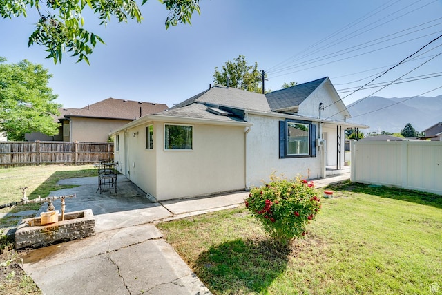 1132 S 1100 W, Provo, UT 84601 - view of front of property featuring stucco siding, a patio area, a mountain view, and a shingled roof