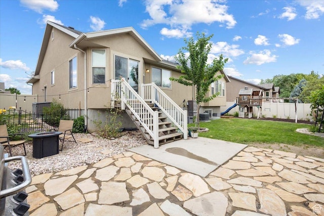 4509 S Greystock Cir W, West Valley City, UT 84120 - rear view of house with an outdoor fire pit, a patio, and stucco siding