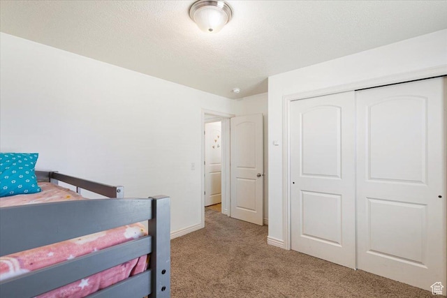 4509 S Greystock Cir W, West Valley City, UT 84120 - carpeted bedroom with a closet and a textured ceiling
