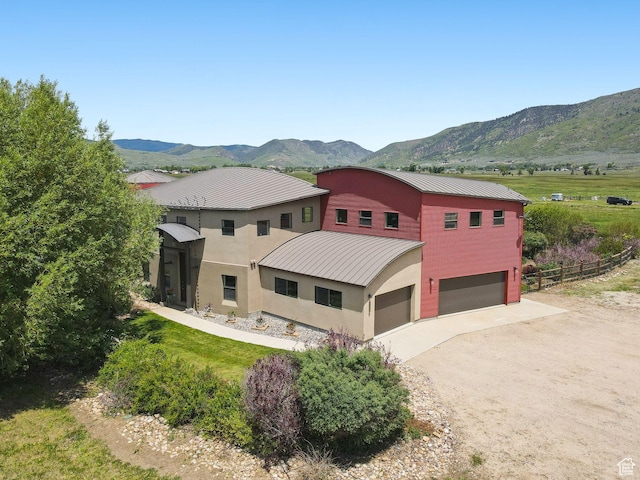 3530 N State Road 32, Marion, UT 84036 - view of front of home with a mountain view, driveway, a metal roof, and an attached garage