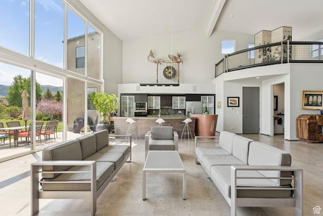 3530 N State Road 32, Marion, UT 84036 - living room with a towering ceiling, healthy amount of natural light, beamed ceiling, and finished concrete floors