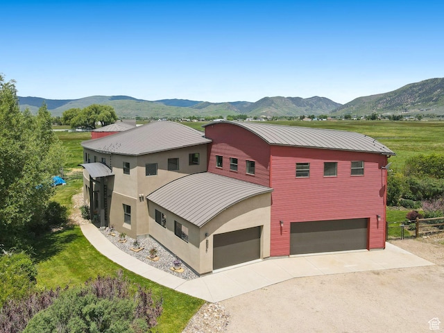 3530 N State Road 32, Marion, UT 84036 - view of front facade with a standing seam roof, concrete driveway, a mountain view, a metal roof, and stucco siding
