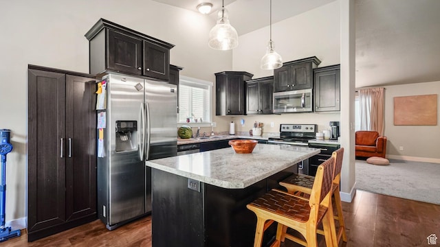 950 N 90 W, Santaquin, UT 84655 - kitchen featuring appliances with stainless steel finishes, a kitchen island, a kitchen bar, pendant lighting, and dark wood-style floors