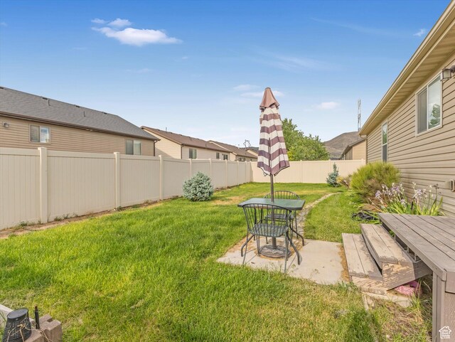 2419 E Hitching Post Dr N, Eagle Mountain, UT 84005 - fenced backyard with outdoor dining space and a patio area