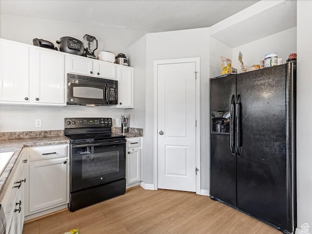 2419 E Hitching Post Dr N, Eagle Mountain, UT 84005 - kitchen featuring black appliances, light wood-type flooring, white cabinets, and light countertops