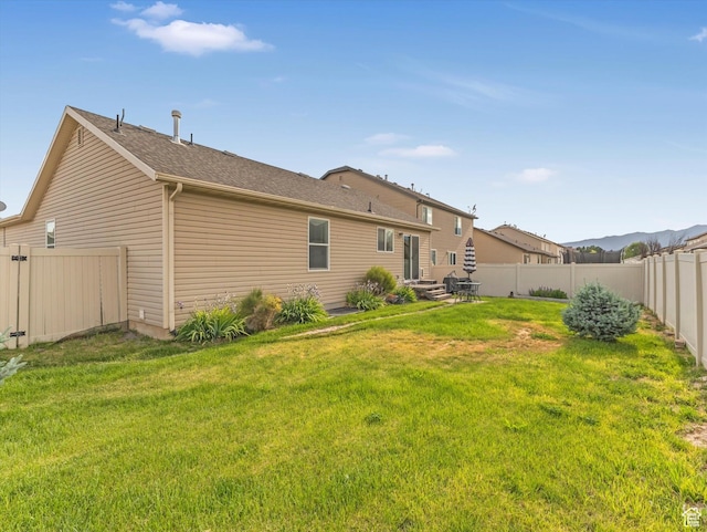 2419 E Hitching Post Dr N, Eagle Mountain, UT 84005 - rear view of property with a fenced backyard and roof with shingles