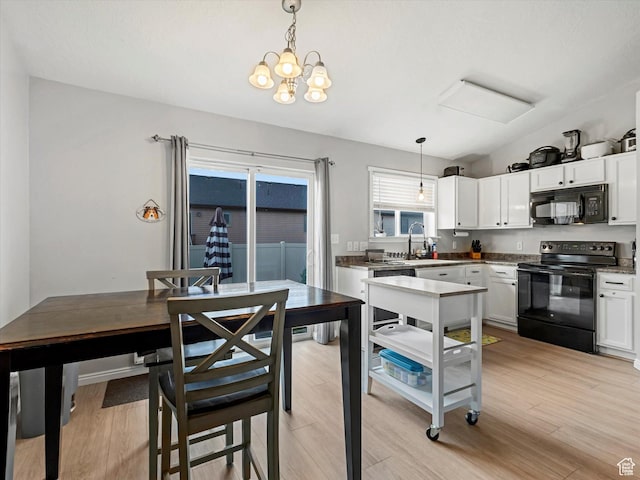 2419 E Hitching Post Dr N, Eagle Mountain, UT 84005 - kitchen with black appliances, white cabinetry, decorative light fixtures, and light wood-type flooring