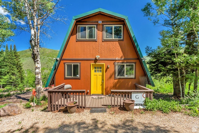 4601 Conifer Dr, Oakley, UT 84055 - a-frame style home with a gambrel roof and a wooden deck