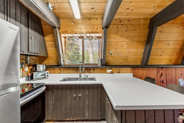 4601 Conifer Dr, Oakley, UT 84055 - kitchen featuring stainless steel appliances, light countertops, wooden walls, a wood ceiling with exposed beams, and dark brown cabinets