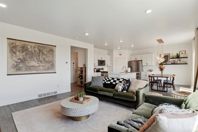 1010 E Bigelow Ave, Layton, UT 84040 - living room with dark wood-style flooring and recessed lighting