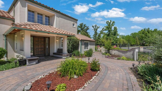 3175 N 140 W, Provo, UT 84604 - mediterranean / spanish house with a tiled roof, stucco siding, a gate, and a porch
