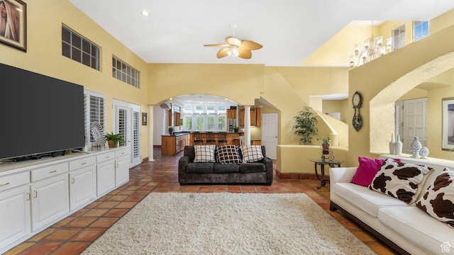 3175 N 140 W, Provo, UT 84604 - tiled living room featuring arched walkways, ornate columns, ceiling fan, and a high ceiling