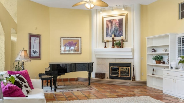 3175 N 140 W, Provo, UT 84604 - living room featuring track lighting, a ceiling fan, a fireplace, and tile patterned floors