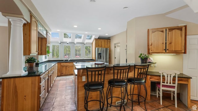 3175 N 140 W, Provo, UT 84604 - kitchen featuring stainless steel refrigerator with ice dispenser, a peninsula, decorative columns, recessed lighting, and a breakfast bar area