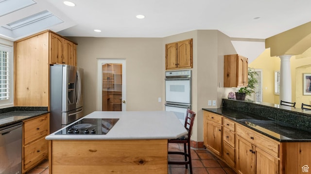 3175 N 140 W, Provo, UT 84604 - kitchen featuring stainless steel appliances, a breakfast bar, a peninsula, a center island, and healthy amount of natural light