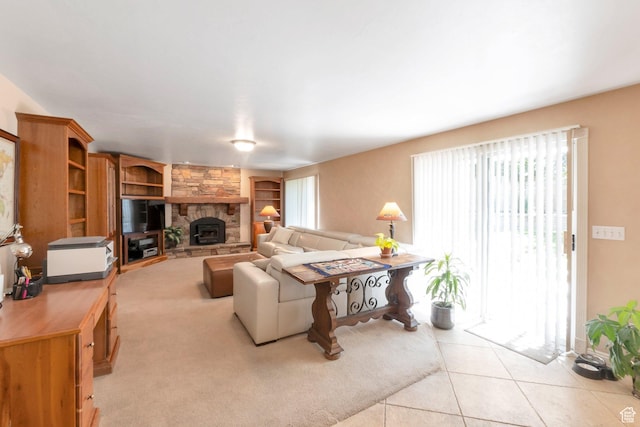 1028 E 140 N, Lindon, UT 84042 - living area featuring built in features, light tile patterned floors, a stone fireplace, and light colored carpet