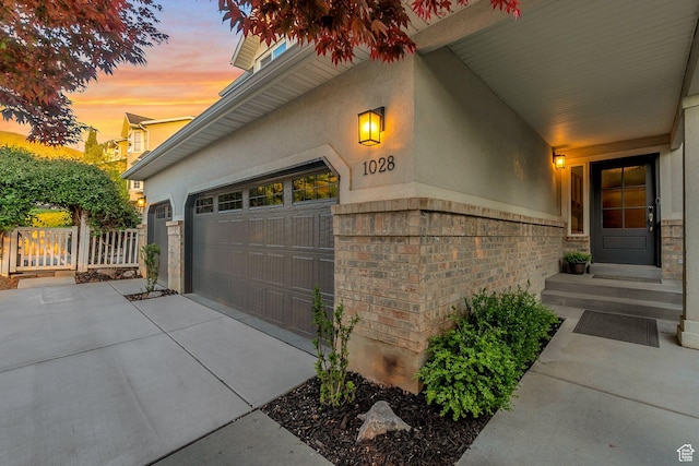 1028 E 140 N, Lindon, UT 84042 - garage at dusk featuring concrete driveway