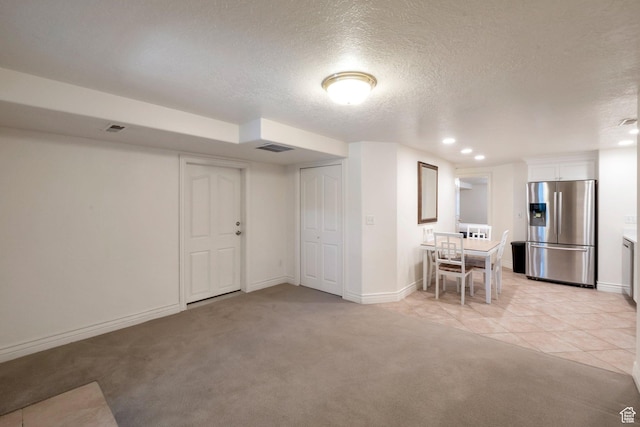 1028 E 140 N, Lindon, UT 84042 - below grade area with stainless steel fridge, a textured ceiling, light carpet, recessed lighting, and light tile patterned floors