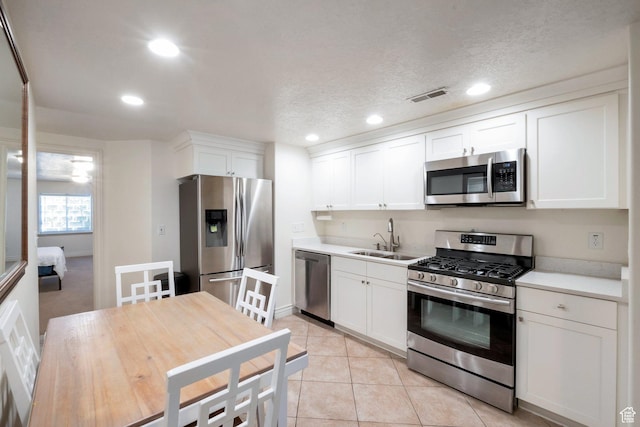 1028 E 140 N, Lindon, UT 84042 - kitchen with appliances with stainless steel finishes, recessed lighting, white cabinets, light countertops, and light tile patterned floors