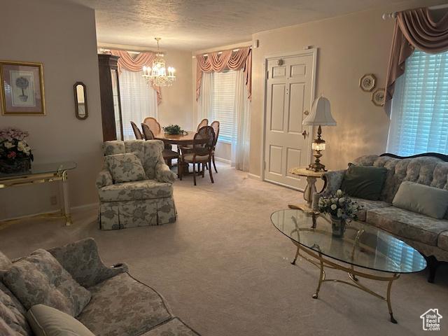 1567 E Westminster Ave, Salt Lake City, UT 84105 - living area featuring a chandelier, carpet flooring, and a textured ceiling