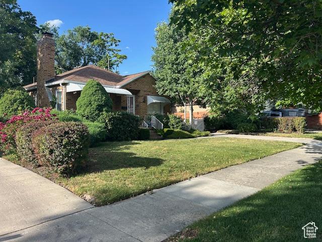 1567 E Westminster Ave, Salt Lake City, UT 84105 - view of front of home with a front yard and a chimney