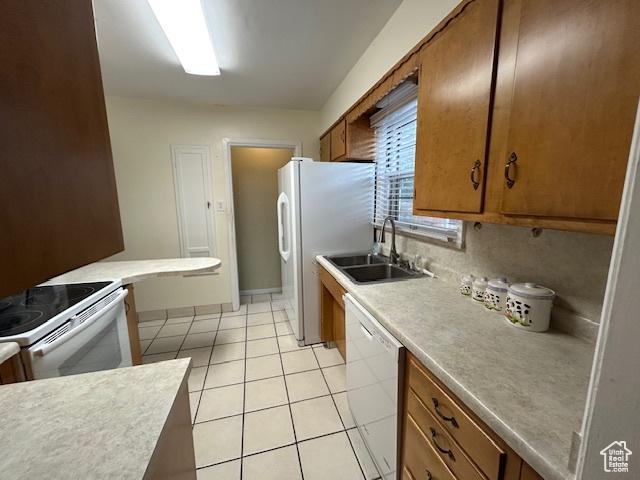 1567 E Westminster Ave, Salt Lake City, UT 84105 - kitchen with white appliances, brown cabinets, light countertops, and light tile patterned floors